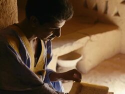 A man reading poetry in the library of Chinguetti Stock Footage