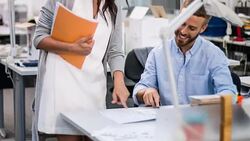 Female Industrial designer discussing project with coworker Stock Footage