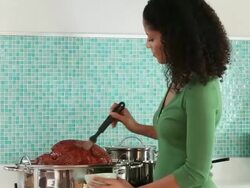 MS PAN Woman Cooking Turkey in Kitchen, Putting in Oven / Richmond, Virginia, USA Stock Footage
