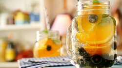 Infused Water with Fresh Blueberries and Oranges Stock Footage