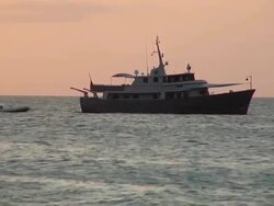 WS View of One boat standing on beach near Santa Maria during sunset / Santa Maria, Sal, Cape Verde Stock Footage