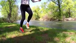Blond woman training with jumping rope outside Stock Footage