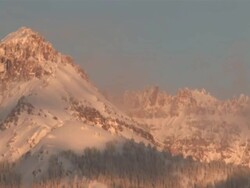 MS T/L View of Clouds and Snow Rolling over Majestic Mountain Peaks in evening Light / Telluride, Colorado, United States Stock Footage