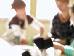 Students and teacher discuss cup in pottery class Stock Footage