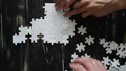 male and female hands  adds white puzzle Stock Footage