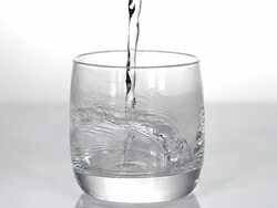 Water being poured into Glass against White Background, Slow motion Stock Footage