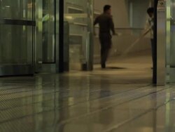 People walk through revolving door at airport Stock Footage