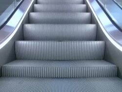 Escalator downstairs 'seamless loop' Stock Footage