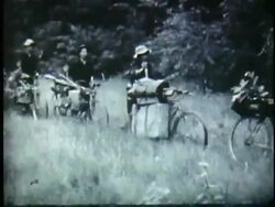 1950s B/W WS Vietnamese peasants transferring supplies by bicycles through jungle / North Vietnam Stock Footage