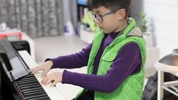 boy playing the piano Stock Footage