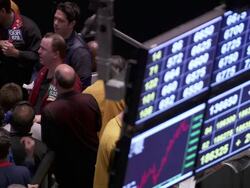 MS Shot of stock exchange screen with people under it speculating / Chicago, Michigan, United States Stock Footage
