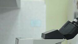 medical technician working in the laboratory hospital with looking through microscope Stock Footage