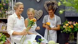 Florists arranging flowers in flower shop Stock Footage