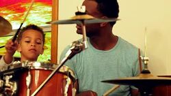 MS Smiling young boy playing drums with father Stock Footage