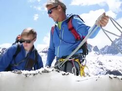 Father and son check GPS for directions while ascending mountain Stock Footage