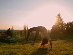 SLO MO Girl makes acrobatic move in meadow Stock Footage