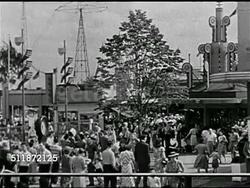 1940: LOS ANGELES: WS Curved highway w/ traffic, cars, city buildings BG. 1947: POST-WAR USA LIFESTYLE: HA MS Family in car w/ luggage rack roof. WS Amusement park. VS People on Bobsled ride. WS Crowded beach, family w/ child, couple laughing. Instructional Video