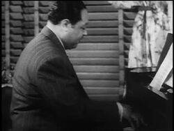 B/W 1930s PROFILE Duke Ellington playing piano near window Stock Footage