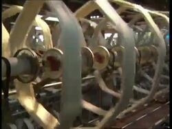 MS Machine spinning thread onto large spools, zoom out Stock Footage