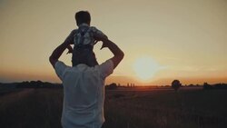 Father and son bonding in a meadow Stock Footage