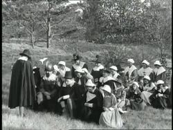 Pilgrims in Massachusetts kneel in a field and pray during a 1660s era reenactment. News Clip