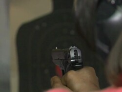 African American Woman Fires a Handgun at a Target Stock Footage