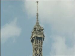CU Eiffel Tower, lift elevator moves up tower, low angle, Paris, France Stock Footage