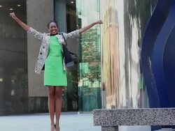 MS ZO Businesswoman jumping and celebrating in front of office building / Richmond, Virginia, United States Stock Footage