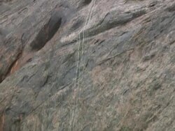 TD Small trickle of water scaling down rocky side of cliff at Arches National Park / Utah, United States Stock Footage