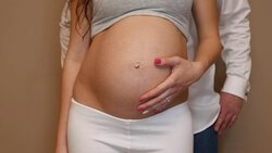 parents-to-be strikng the big belly Stock Footage