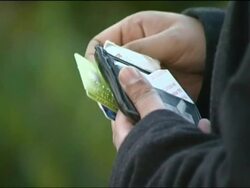 Reconstruction of a Credit Card Fraudster looking through a stolen wallet Stock Footage