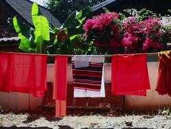 MS Shot of saffron clothes hanging on for drying / Luang Prabang, Laos Stock Footage