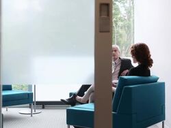 MS PAN businessman and businesswoman in discussion in office/Seattle, Washington, USA Stock Footage