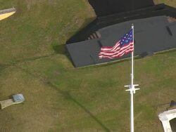 MS AERIAL ZO Shot of flag waving on Fort Moultrie / South Carolina, United States Stock Footage