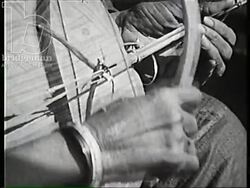 Tuareg tribe at camp, playing and listening to music. Man holds woman's hand (courting?). Algeria 1957 Stock Footage