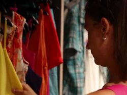 Young woman choosing clothes Stock Footage