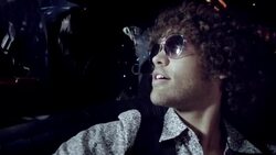 Rockstar strums on acoustic guitar in limo while fans bang on windows and paparazzi snap photos at awards show Stock Footage