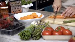 Unrecognisable woman chopping a carrot for her meal Stock Footage