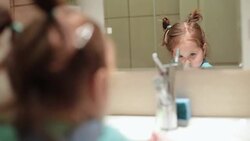 Little baby girl brushing teeth by herself Stock Footage