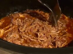 Pulled pork with BBQ sauce cooked with a slow cooker Stock Footage