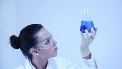 Science. Female lab worker and glass flask. Stock Footage