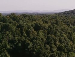 Aerial flying over countryside, hills and mountains  in the late afternoon Stock Footage