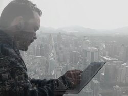 Composite image of man using tablet device and city Stock Footage