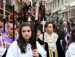 Parade of young people with Costaleros bearing a Trono a religious float during Semana Santa, a procession through the streets of Malaga, Spain, Europe Stock Footage