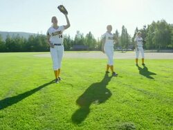 MS Smiling female softball teammates warming up in field before game Stock Footage
