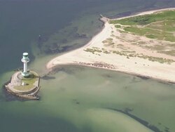 AERIAL MS View of small lighthouse / Kiel Canal, Schleswig-Holstein, Germany Stock Footage