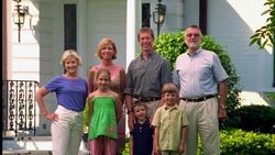 A family stands in front of their suburban home. Stock Footage
