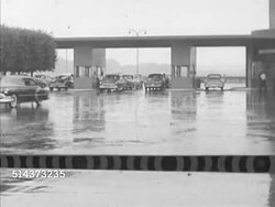 1952: CANADA: BORDER CROSSING: WS Cars in line & moving out of booths in rain. PAN Unrolled map on desk to Canadian Minister of Transport Lionel Chevrier (1903-1987), SOT saying glad St. Lawrence Seaway is to be completed, none to soon. Instructional Video