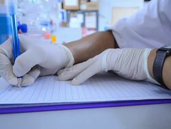 Scientist writing notebook in laboratory Stock Footage