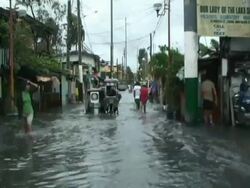 Motorbikes driving through flood waters in Cupang in aftermath of typhoon Mirinae, Philippines, 2009 Stock Footage